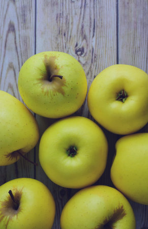Yellow apples on old woods, copy space and top view.
