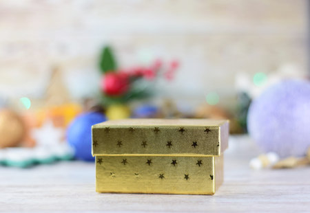 Golden box, small gift, Christmas colorful decoration background.