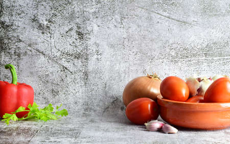 In stone bottom, natural beneficial ingredients, tomatoes, garlic and several others, copy space.の写真素材