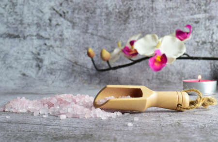 Wooden spoon with bath salts, for relaxing moments. Stone background.の写真素材