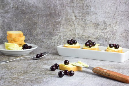 Blueberrie on toast with butter and scattered on stone background.