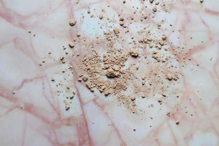 Chocolate powder spread on marble with abstract shapes.の写真素材