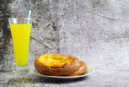 Sweet and traditional ensaimada covered with cream, accompanied by an orange soda.の写真素材