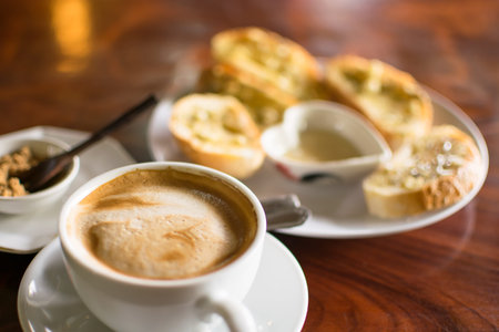 Coffee cup with garlic bread in coffee shop - vintage style effect picture
