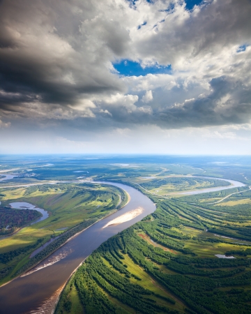 Aerial view the river during summer day under the great clouds の写真素材