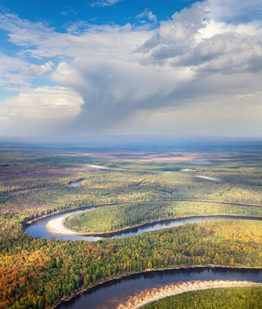 Aerial view of the river executing the loop during the cloudy day of autumn.の写真素材