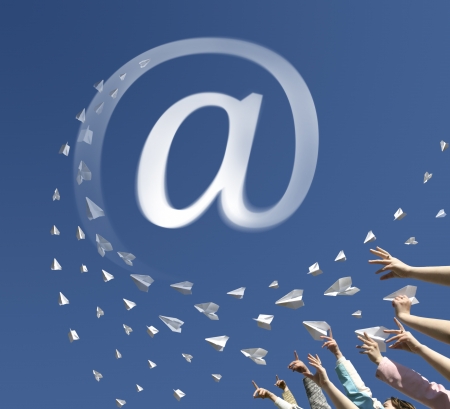 The hands of children throw upwards messages in the manner of paper airplanes. Airplanes converted to an symbol of email address.の写真素材