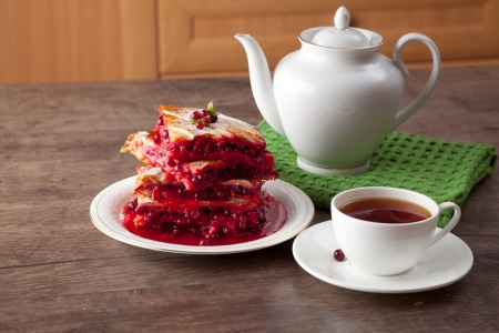 Cranberry Pie for Christmas and tasty tea with foxberry leafs are on wooden table の写真素材