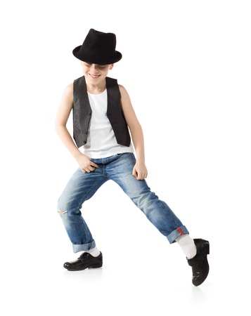 Little boy in jeance and hat is dancing on whiteの写真素材