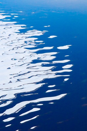 Shoal River after the first snowfall, view from above. Aerial view bizarre river coast after falling water level and first snowfall.の写真素材