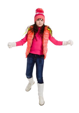 Jumping girl in winter clothes, isolated on whiteの写真素材