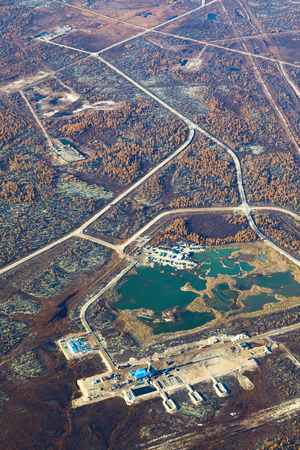 Aerial view of the oilfield in tundra in autumn. Some gas pipelines running from gas field in tundra. Oil pumps are located in the foreground.の写真素材