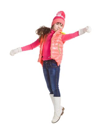 Jumping girl in winter clothes, isolated on white backgroundの写真素材