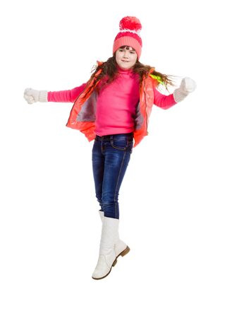 Jumping girl in winter clothes, isolated on white backgroundの写真素材