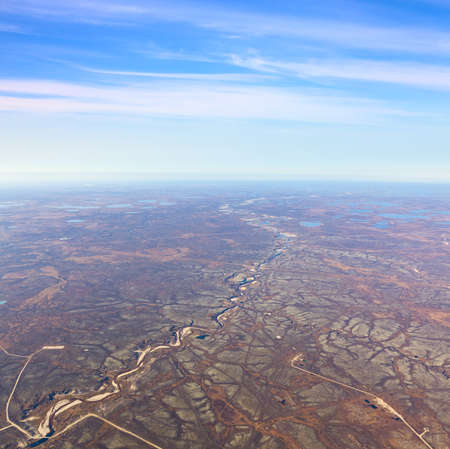 Aerial view of the tundra in autumn. Marsh with water under cloudy sky.の写真素材
