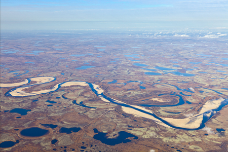 Aerial view of the tundra in autumn. Marsh with water under cloudy sky.の写真素材