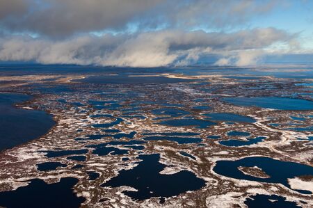 Swampy tundra were covered by the first snow in start of winter from aboveの写真素材