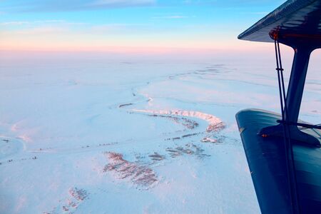 Flight above endless tundra in winterの写真素材