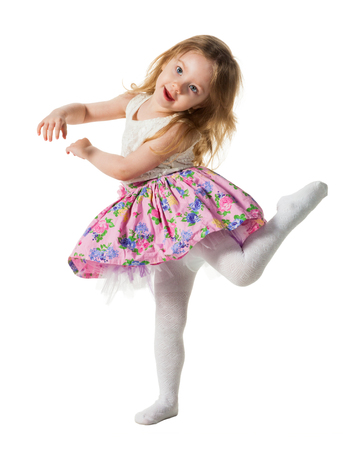 Cute little girl jumping with joy isolated on white backgroundの写真素材