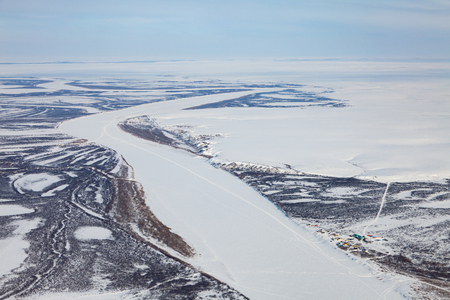 River in winter tundra from aboveの写真素材