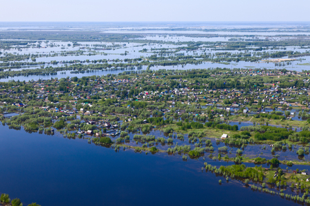 Flooded houses in the floodplain of a large river during the spring flood, bird's eye viewの写真素材