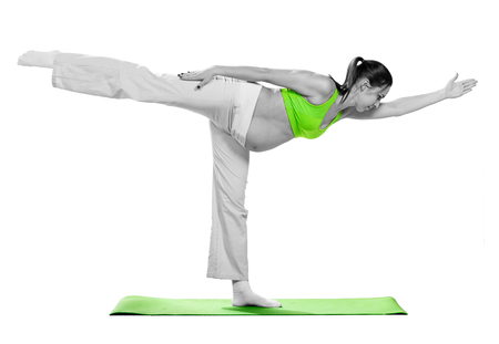 Pregnant woman doing stretching exercise during workout, isolated on white backgroundの写真素材