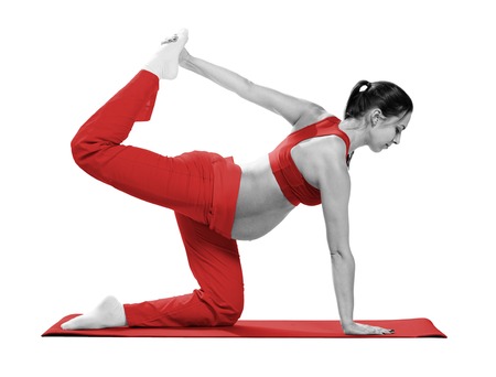 Pregnant woman making exercise, isolatedの写真素材