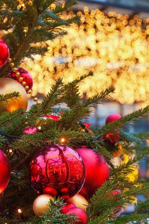 Christmas balls on tree branches and street decorations for New Year and holidays.の写真素材