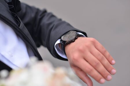 Mens business wrist watches. A look at the watch, before the meeting.の写真素材