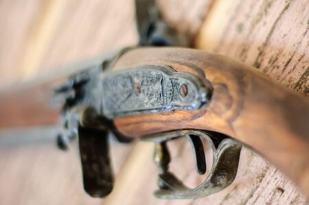 Old, rusty gun on the wall. Rusty weapons on the wall.の写真素材