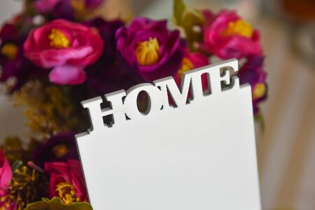 The lettering home on the floral purple background. Text home, close-up.の写真素材