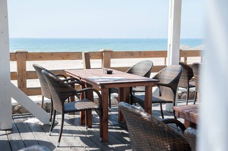 Cafe summer terrace with sea view. Tables and chairs on the summer terrace.の写真素材