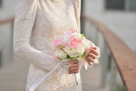 Bouquet in the hands of the bride. The bride in a beautiful wedding dress with a wedding bouquets.の写真素材