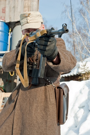 outdoor  soldier with mashinegun takes aimの写真素材