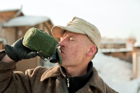 soldier drinks from a flaskの写真素材