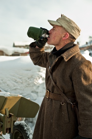 soldier drinks from a flaskの写真素材