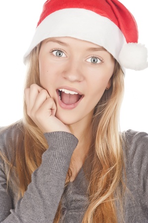 cheerful girl with a white-toothed smile in Santa Claus hat, close-up portrait, snow-white smileの写真素材