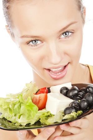 closeup portrait of attractive girl with a plate of vegetable saladの写真素材