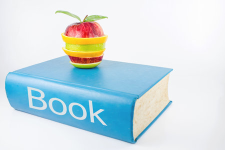Book and an fruits on a white background の写真素材