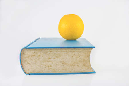 Book and orange on a white backgroundの写真素材