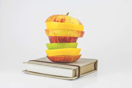 Book and an fruits on a white background の写真素材