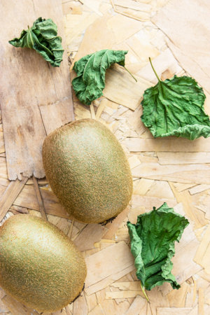 Bunch of fresh kiwi fruit on a woodenの写真素材