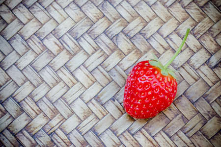 Fresh red strawberry on tray bamboo backgroundの写真素材