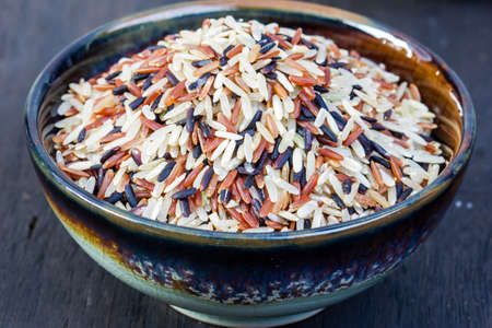 Assorted types of rice in ceramic bowlsの写真素材