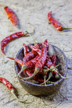 Dried chili peppers in a wood bowlの写真素材