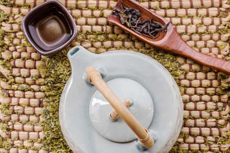 Frame with Asian teapot. cup of tea and teapot on woodenの写真素材