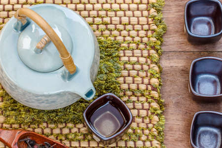 Frame with Asian teapot  cup of tea and teapot on woodenの写真素材