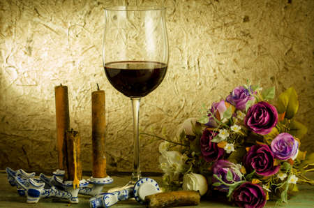 red wine and glass on a old paper backgroundの写真素材