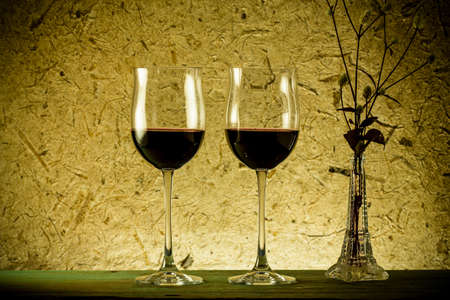 red wine and glass on a old paper backgroundの写真素材