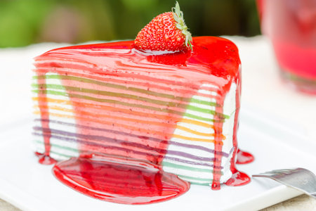 Rainbow cheesecake with fresh strawberries